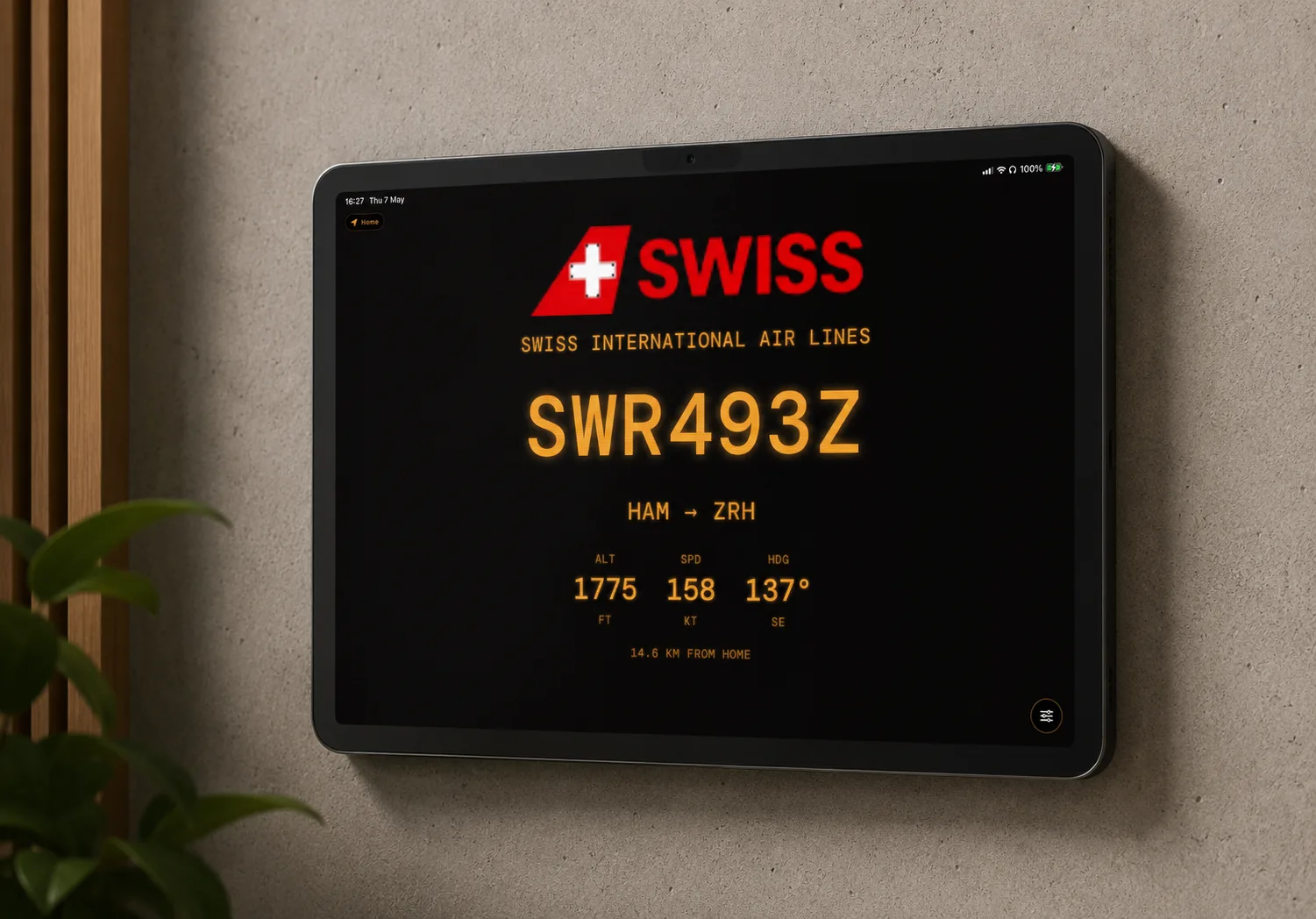 Wall-mounted iPad showing the LED theme with live flights overhead — screenshot placeholder
